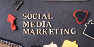 A gray notebook with the words "social media marketing" in gold lettering on the front.