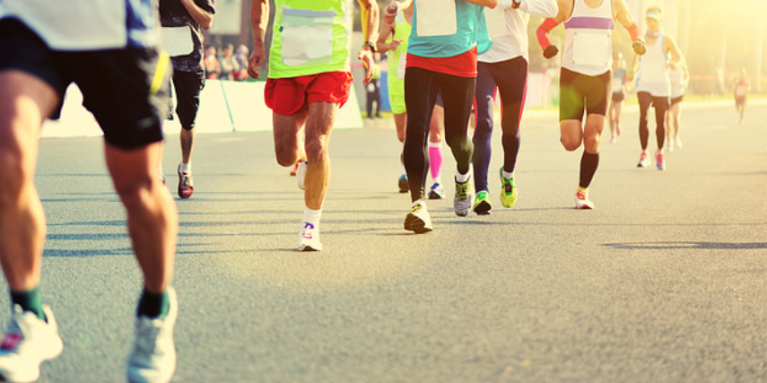 Street-level view of a group of runners in a 5K.