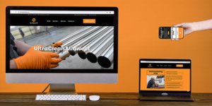 Image displaying a desktop monitor, tablet and smart phone with coordinating webpages against an orange backdrop.