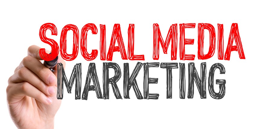 A hand writes "Social Media Marketing" across a white background in marker-like font.
