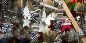 Wooden tree shapes and pinecones are displayed at a Christmas shop.