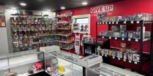 Interior photo of a sports memorabilia store, with red walls and racks of merchandise.