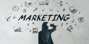 Back view of a woman looking at a wall full of marketing icons, scratching her head in confusion.