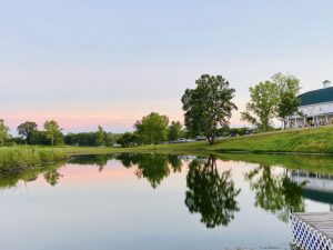 Outside view shows pond and a sunset outside wedding venue.