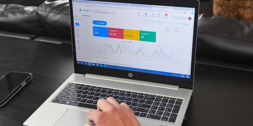 A laptop showing metrics for digital marketing with colored blocks against a white background on the screen.