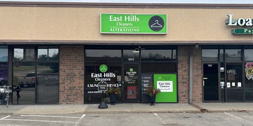 Front view of a dry cleaning company located in a strip mall. 