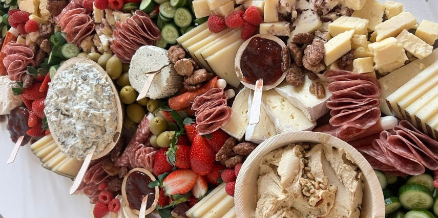 Cheese, fruit, veggies and spreads all arranged as a charcuterie board. 