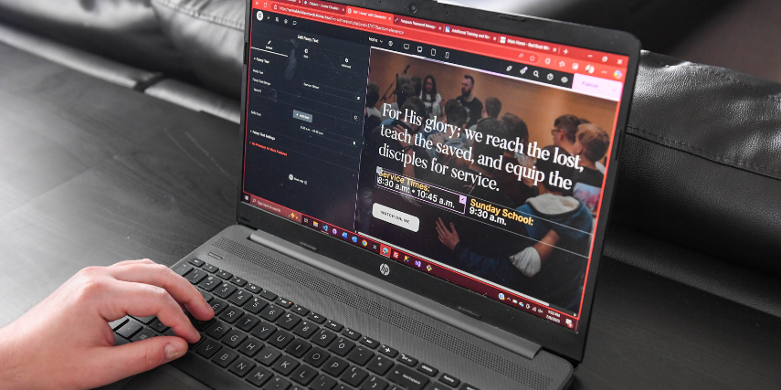 A web developer works on a website design for a private school.