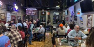 Inside view of Jake's Steakhouse and Sports Bar, filled with patrons enjoying food.