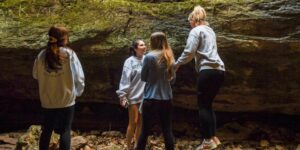 Four young women explore geologic formations in Rock Bridge Memorial State Park.