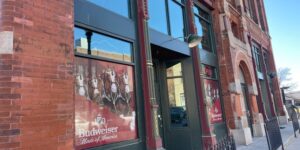 View of the entrance of Jake's Steakhouse and Sports Bar, housed in a large brick building.