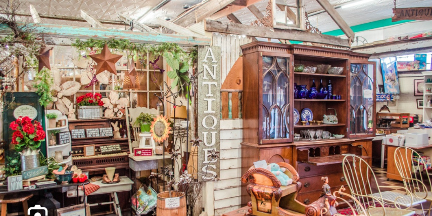 Interior of an antique shop, showing a display of items for sale.