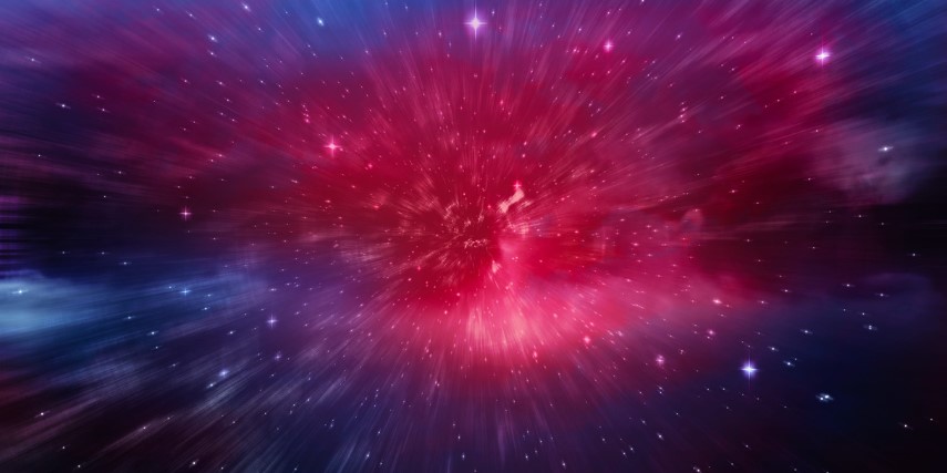 A red, glowing light at the center of a blue area in space. 