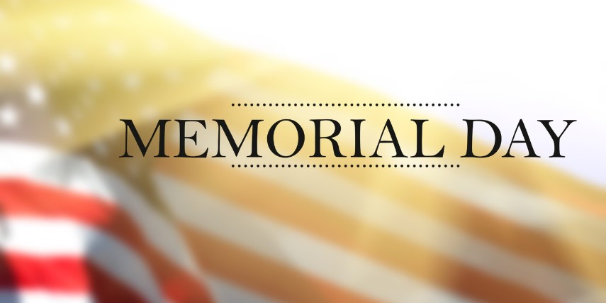 The words Memorial Day against the backdrop of an American Flag.