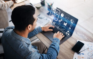 SEO, digital and businessman with laptop in an office for analysis, email or work on technology. Website, corporate and an employee typing on a computer for marketing or professional market research