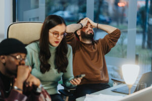 Frustrated business team working late hours at office.