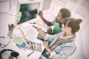 High angle view of two artists working on computer at the office