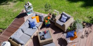 Overhead view of a backyard deck with a couch, chair and table.