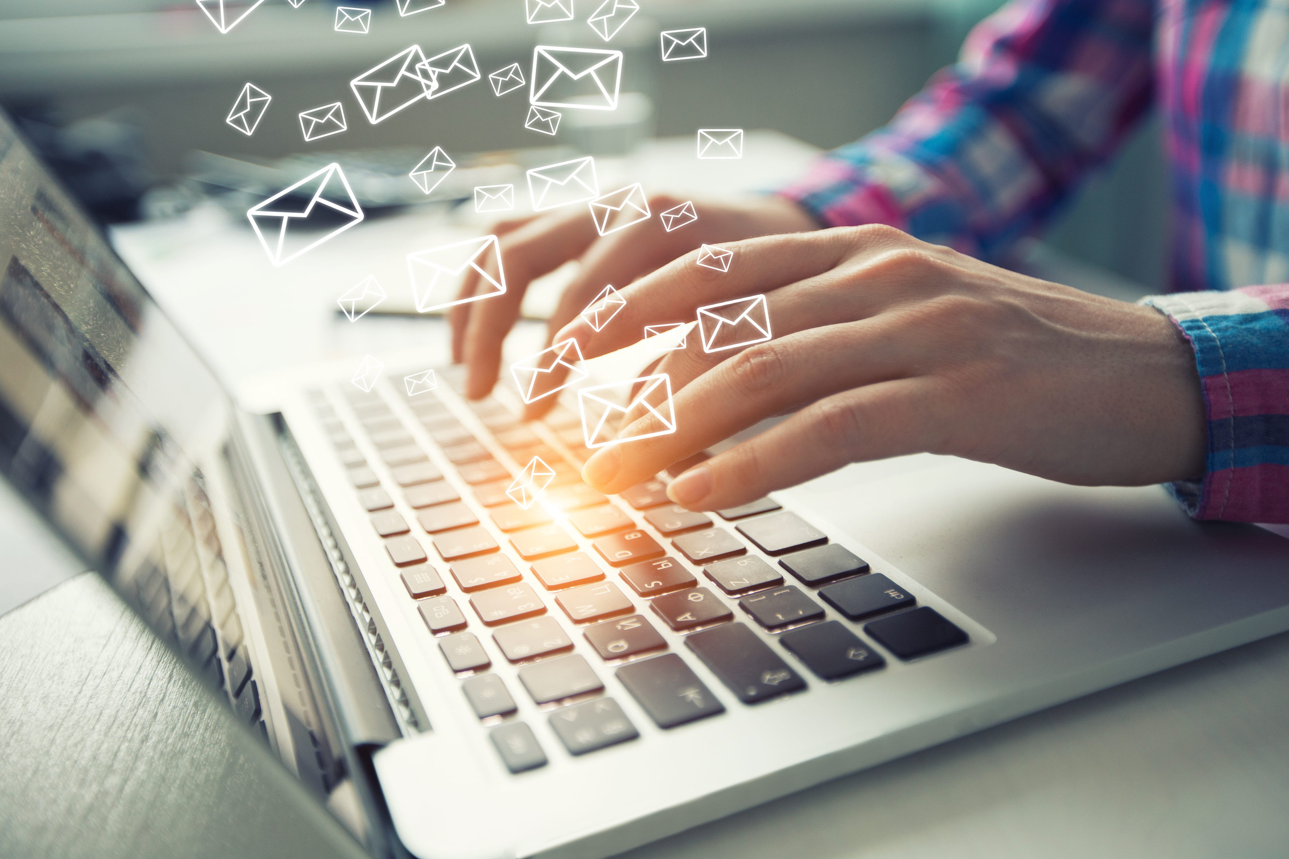 Media Distribution Businessman is sending emails with laptop at workspace.