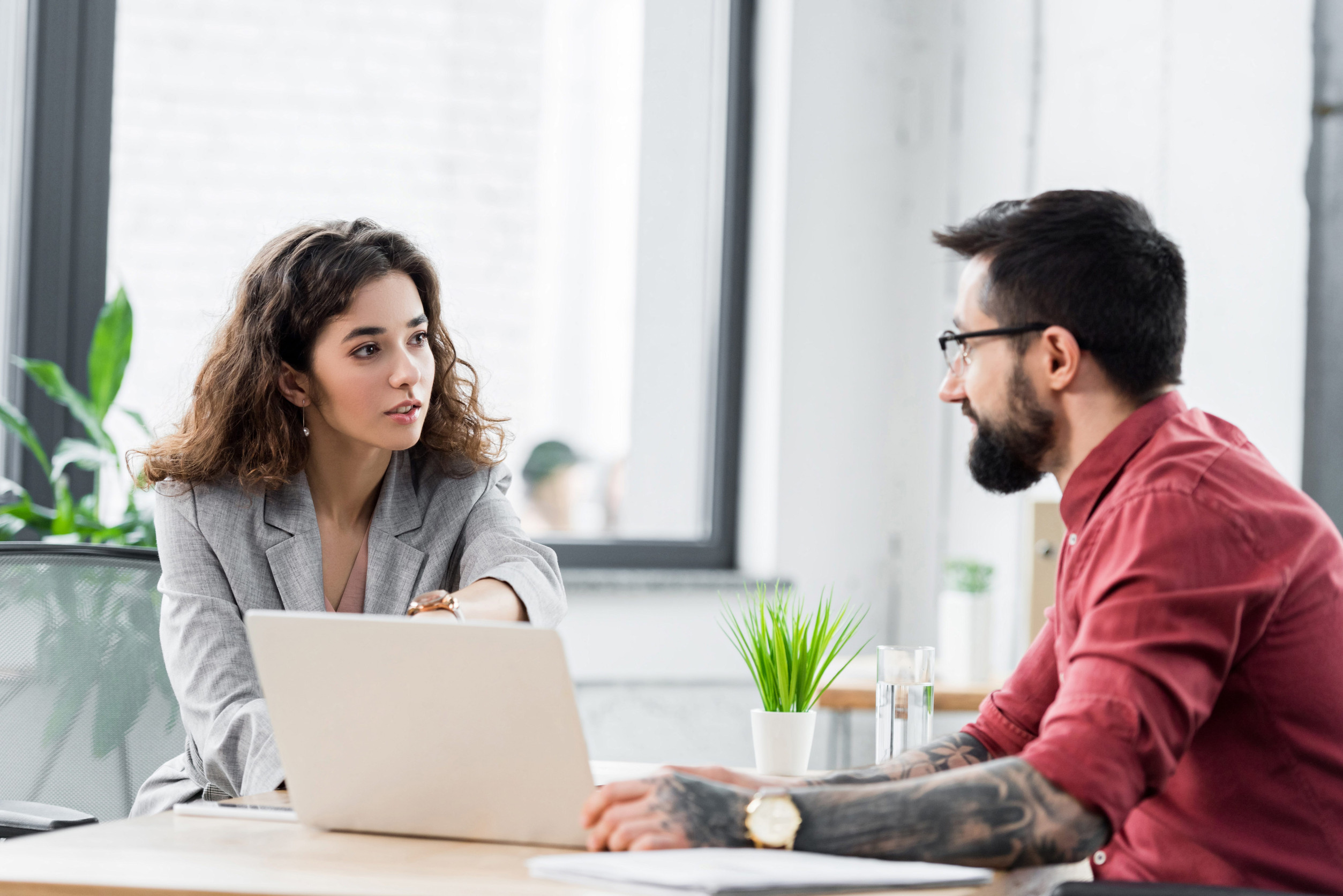 Ongoing Support account managers talking and sitting at table in office