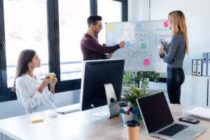 business team talking to their colleagues in white blackboard