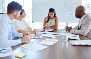 Planning, project management and review with business people in meeting for marketing strategy, documents or collaboration. Idea, analytics and teamwork with employee working on data on future vision