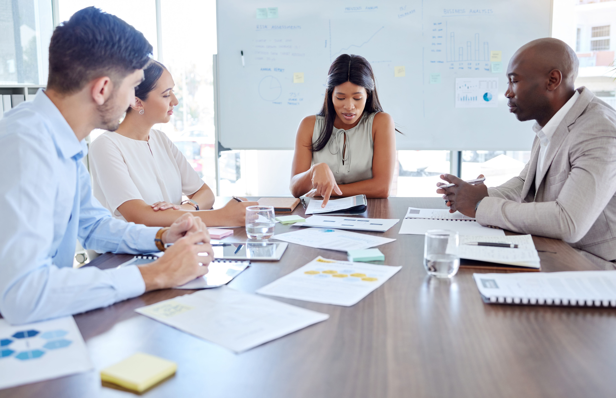 Consultative Sessions Planning, project management and review with business people in meeting for marketing strategy, documents or collaboration. Idea, analytics and teamwork with employee working on data on future vision