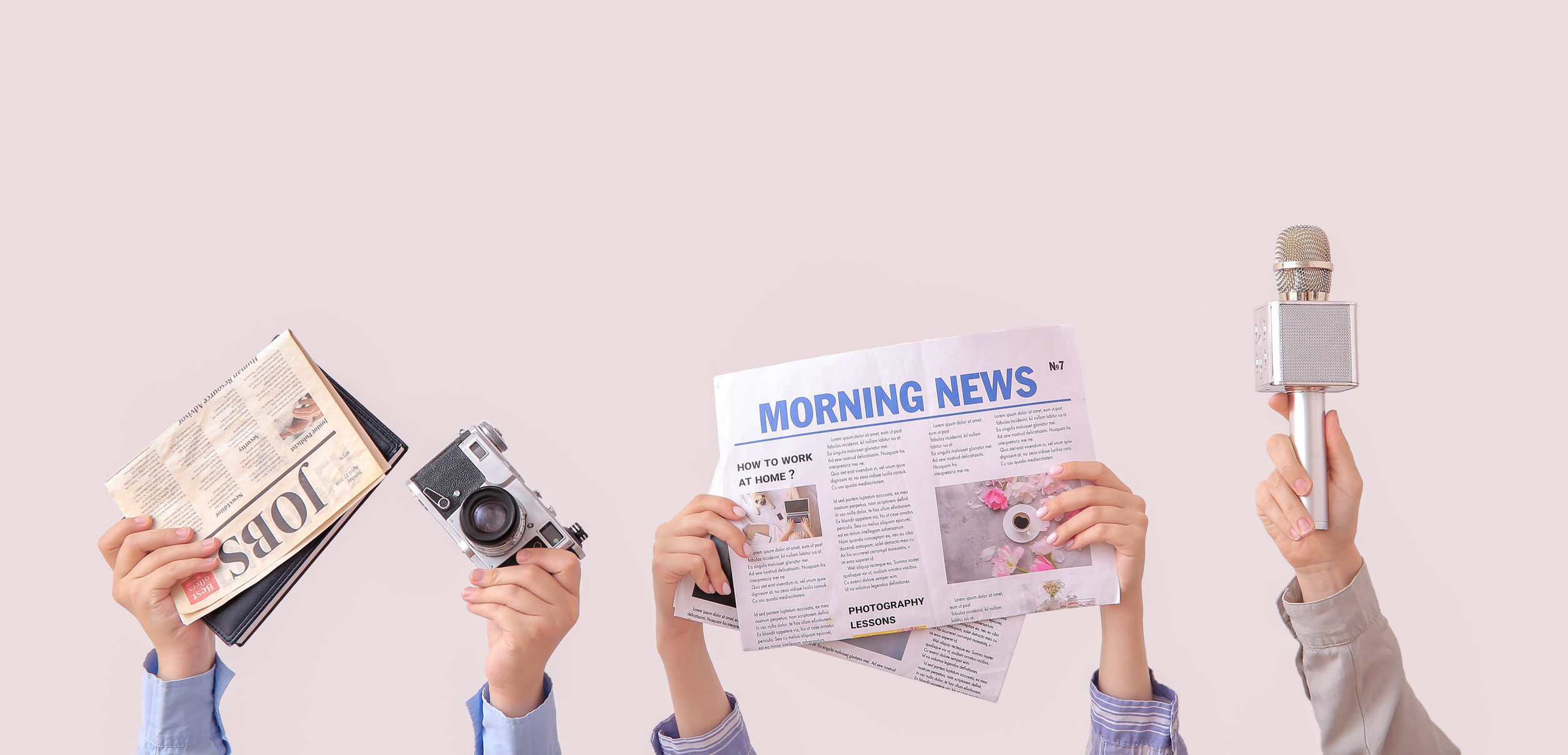 Female hands with newspapers, photo camera and microphone on light background
