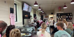 A crowd lines up at the counter at Palmer's Ice Cream, ready to order.