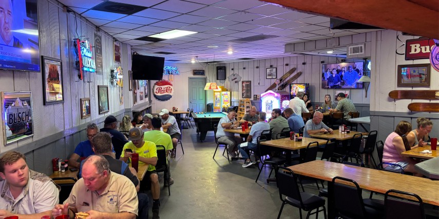 Interior view of Adams Bar and Grill in St. Joe, featuring patrons enjoying a good meal.