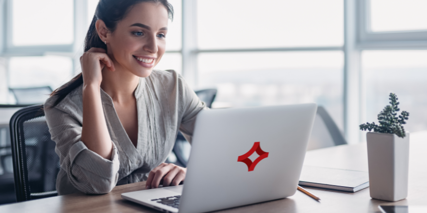 A woman sits at a laptop with the SJC logo featured on the cover.