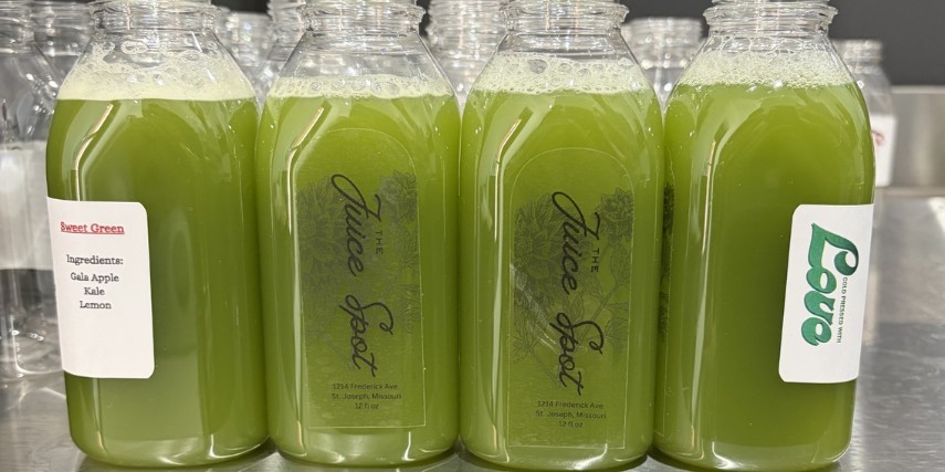 Green juice in bottles on aa shelf