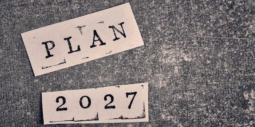 A mottled gray surface with two pieces of paper on it. Stamped on the papers are "plan" and "2027."